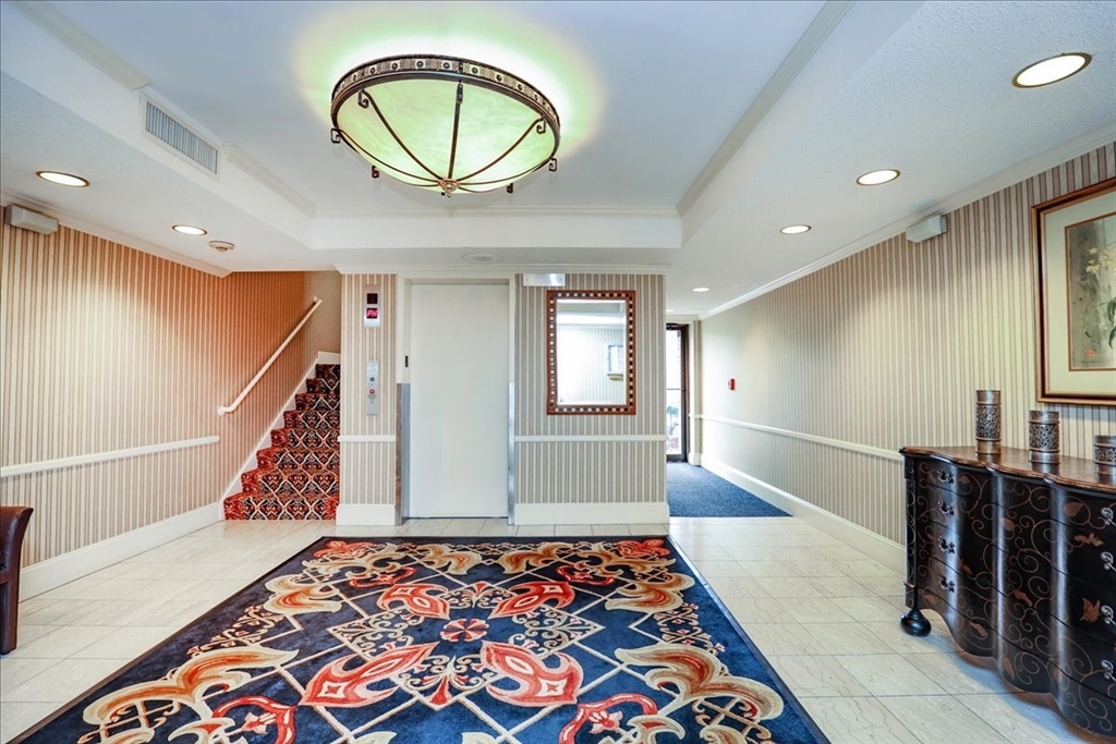 1004 Paradise Road, Unit 1L Swampscott, MA 01907 - Photo 12 of 28 a view of an entryway with wooden floor