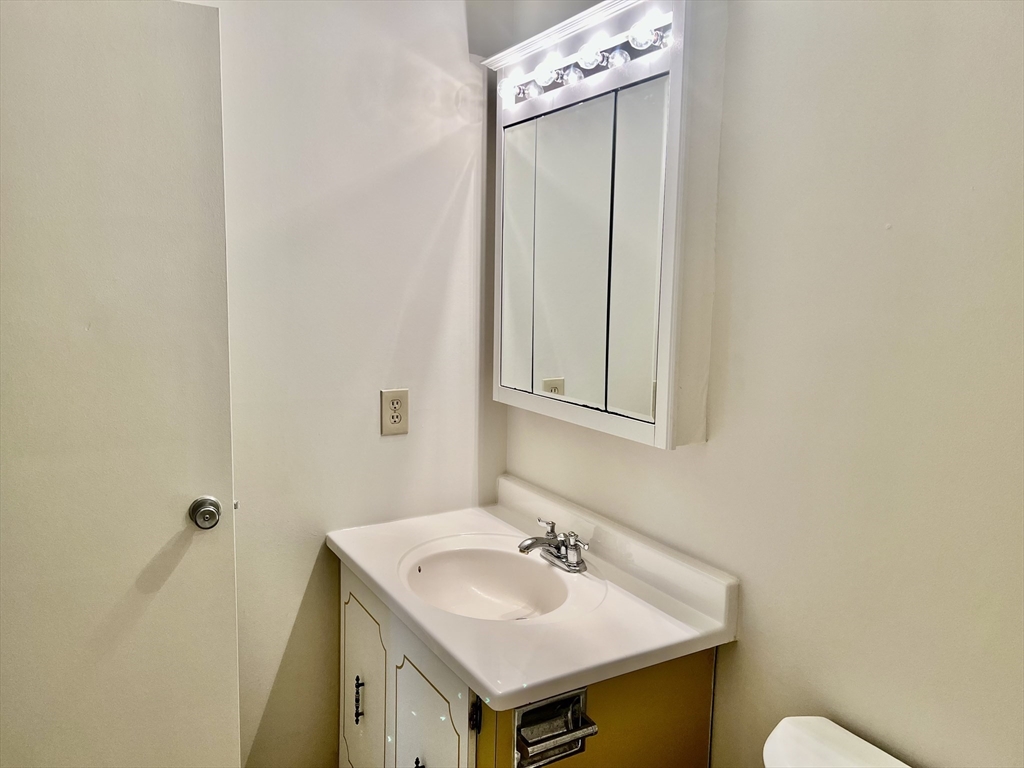 1004 Paradise Road, Unit 1L Swampscott, MA 01907 - Photo 26 of 28 a bathroom with a sink and a toilet