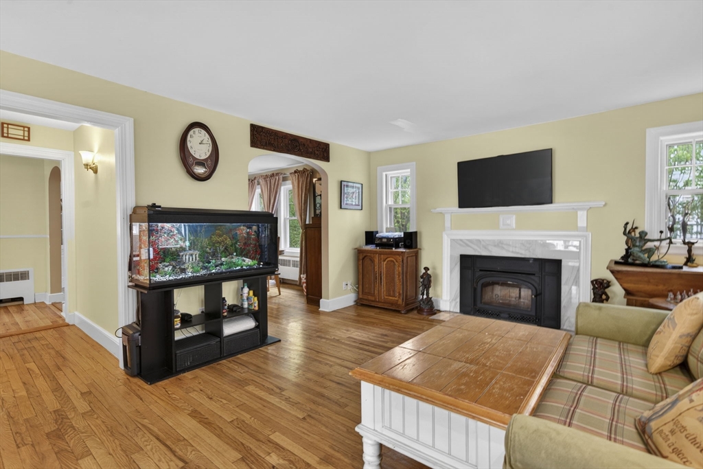 229 Parkerville Road Southborough, MA 01772 - Photo 27 of 38 a living room with furniture a flat screen tv and a fireplace