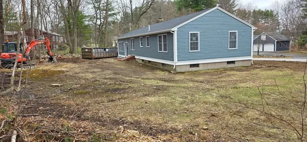 a view of a small house with a yard