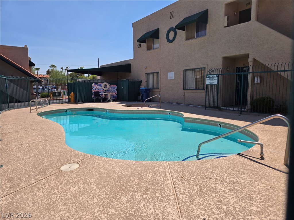 6750 Del Rey Avenue, Unit 133 Las Vegas, NV 89146 - Photo 33 of 34 An inviting, freeform pool awaits, perfect for a refreshing dip on a warm day.