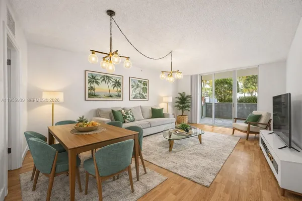 a living room with furniture a table and a flat screen tv