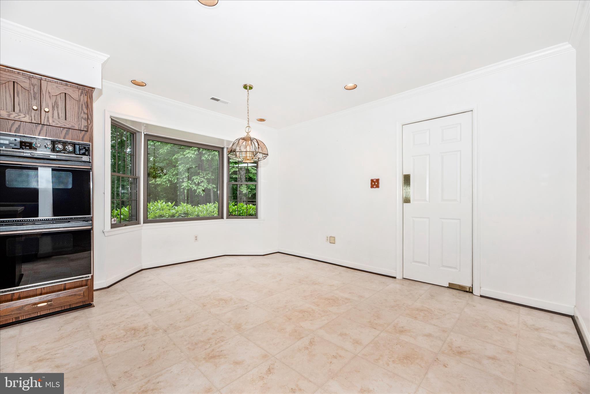 2221 Gold Mine Road Brookeville, MD 20833 - Photo 12 of 60 a view of an empty room with a window and kitchen view