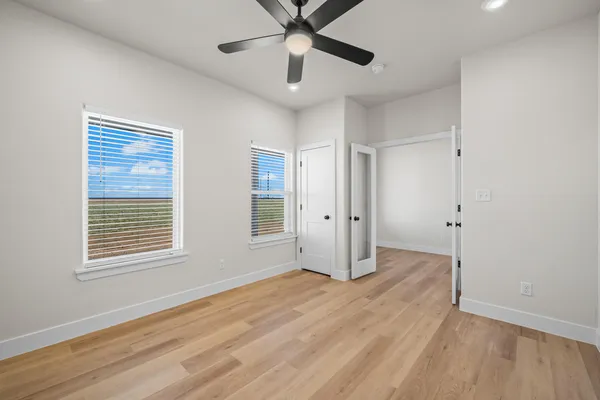 a view of a hallway with wooden floor