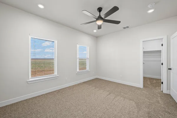 an empty room with a empty space and a ceiling fan