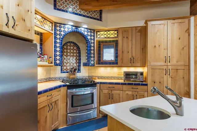 a kitchen with stainless steel appliances granite countertop a stove and a sink