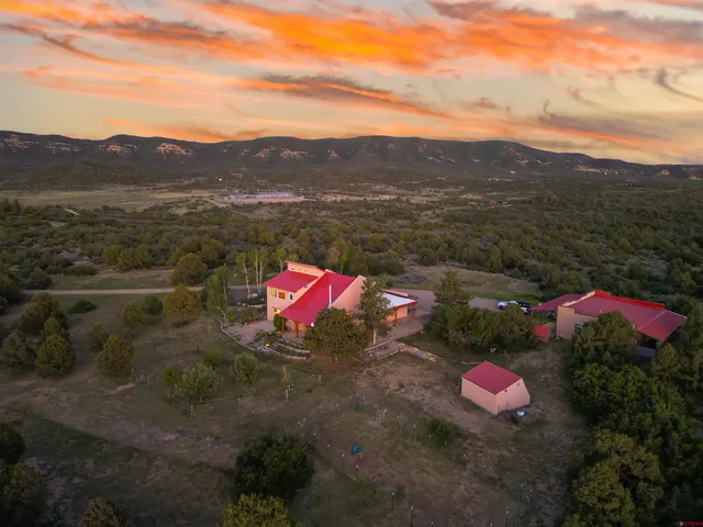 a view of a lush green hillside and a houses