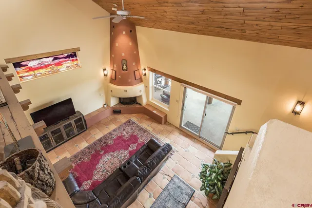a view of a livingroom with furniture and a potted plant