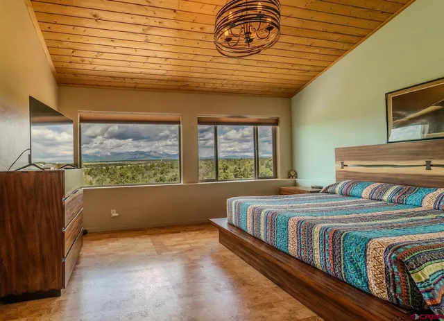 a bedroom with a bed and a large window