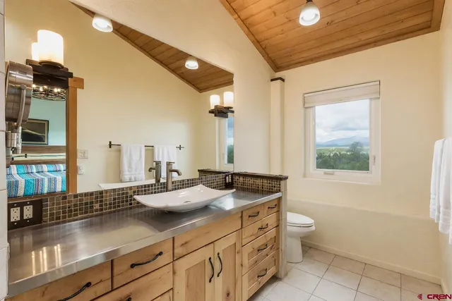 a bathroom with a shower sink and mirror