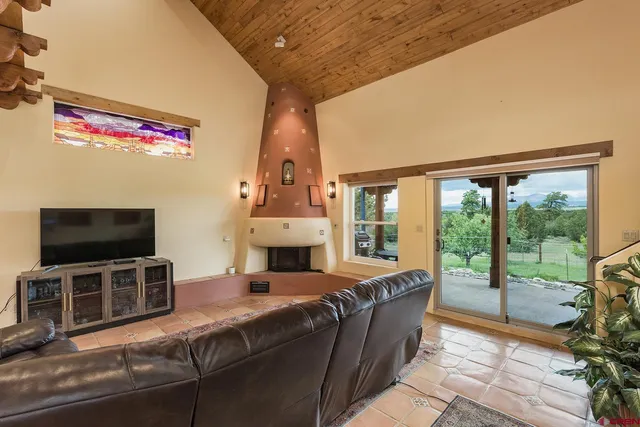 a living room with fireplace furniture and a flat screen tv