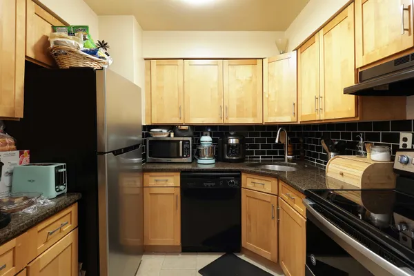 a kitchen with a sink stove and refrigerator