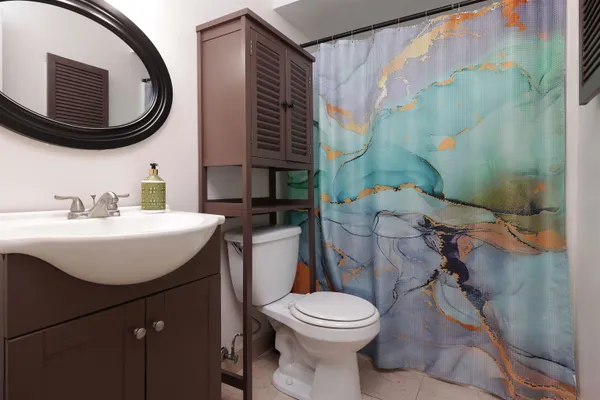 a bathroom with a sink a toilet and a mirror