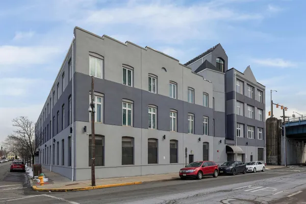 a city street lined with parked cars and buildings