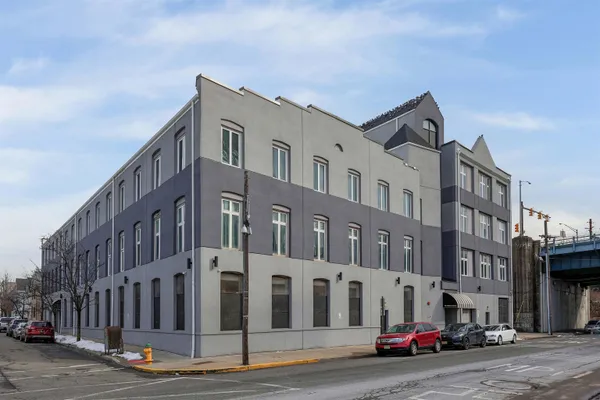 a city street lined with buildings and cars parked on the side of a street