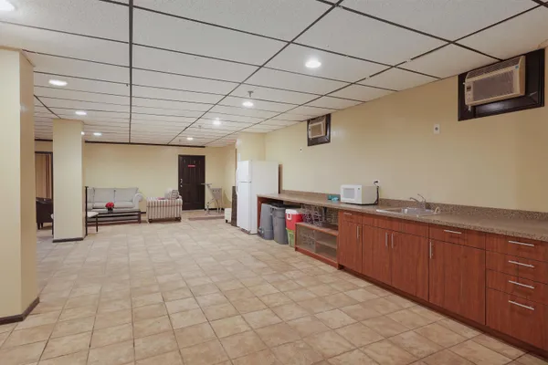 a large kitchen with stainless steel appliances granite countertop a sink and cabinets