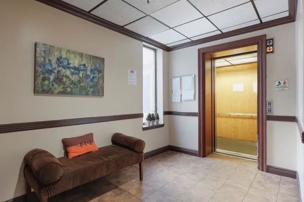 a hallway with furniture and a potted plant