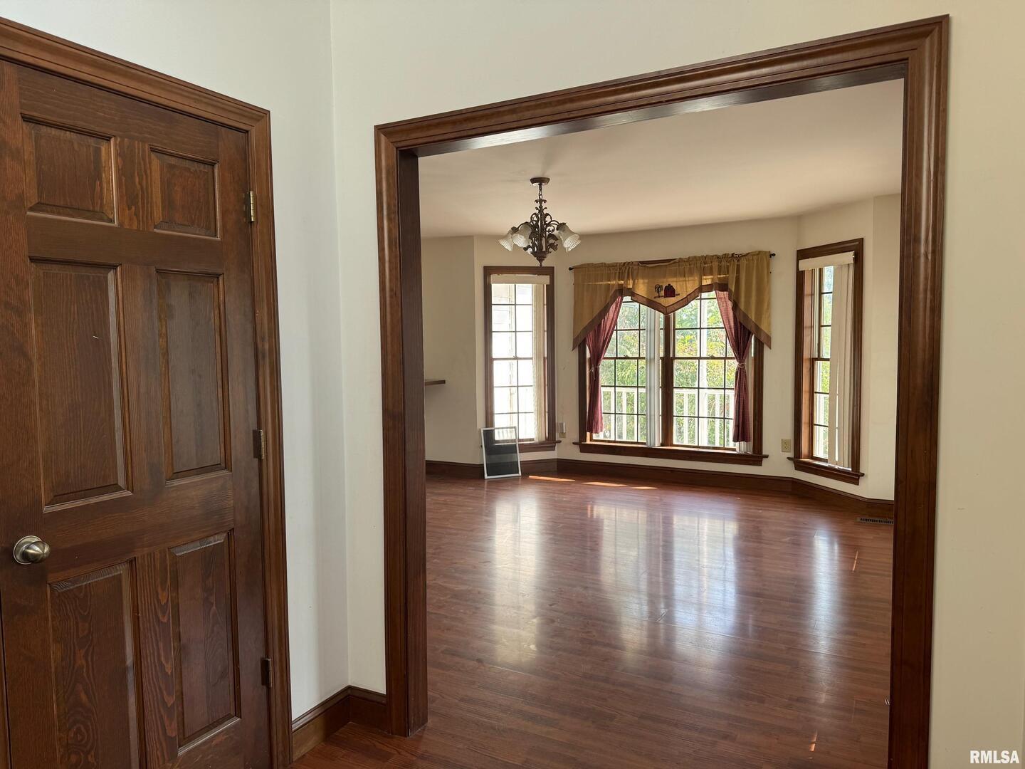 102 West North Street Benton, IL 62812 - Photo 14 of 56 wooden floor in an empty room with a window