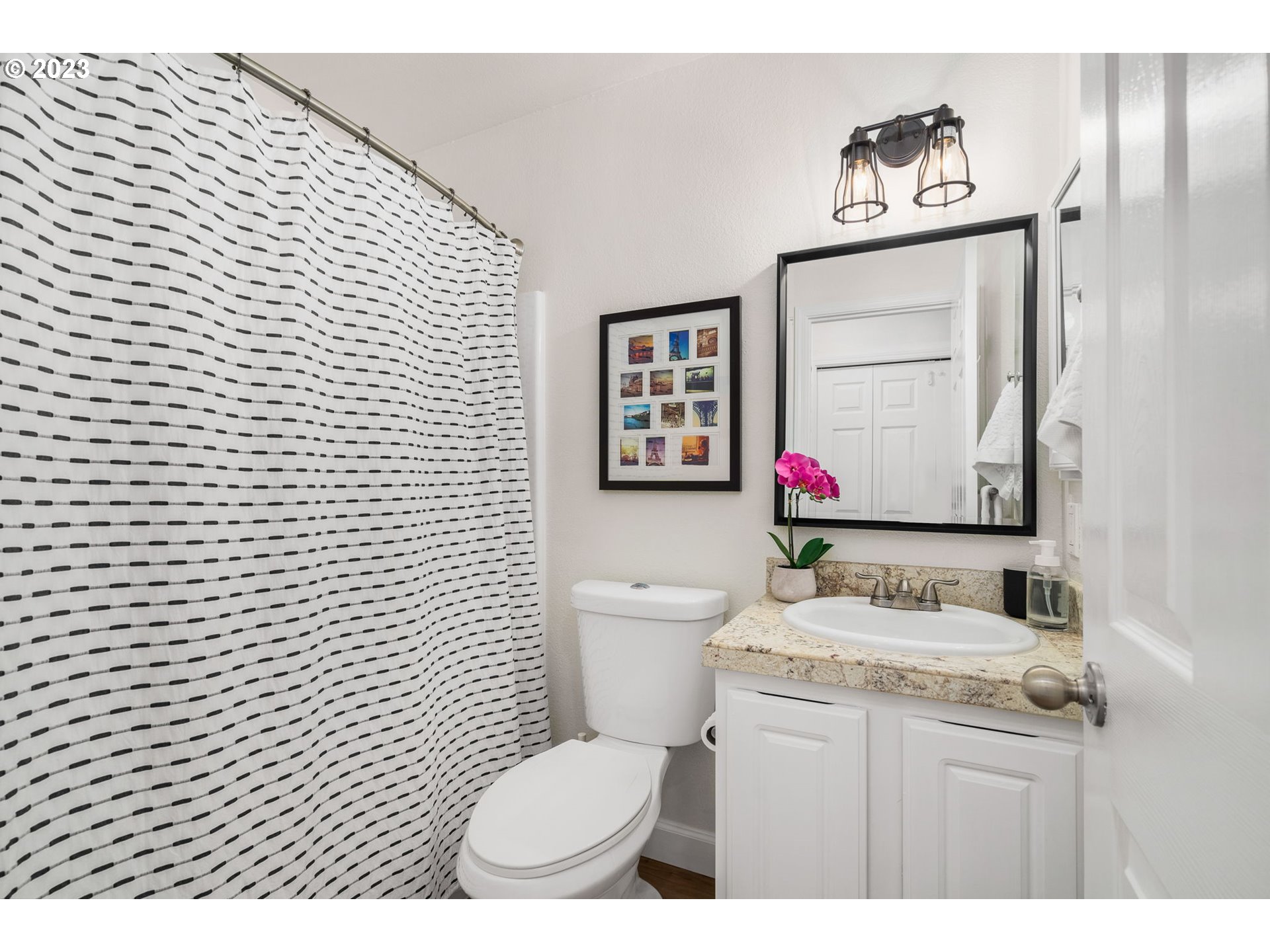 9340 Southwest 146th Terrace, Unit K7 Beaverton, OR 97007 - Photo 11 of 18 a bathroom with a toilet sink vanity and mirror