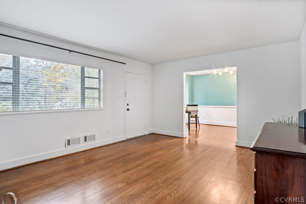 3829 Arklow Road Richmond, VA 23235 - Photo 5 of 24 an empty room with wooden floor and windows