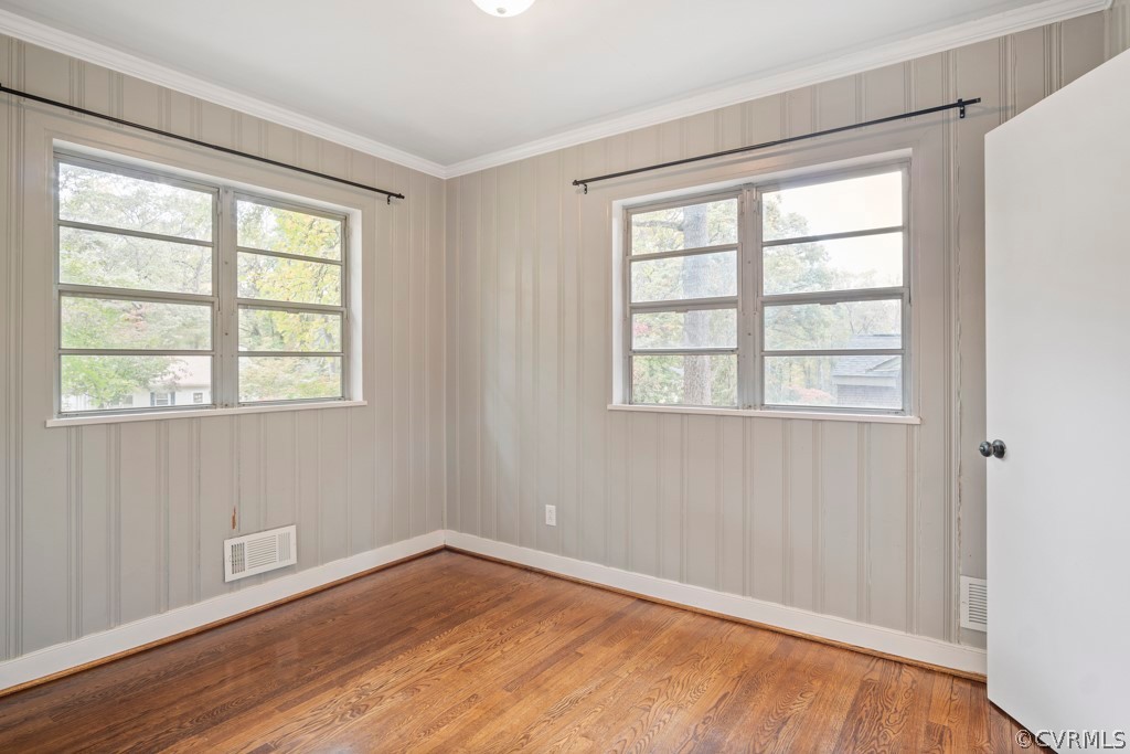 3829 Arklow Road Richmond, VA 23235 - Photo 8 of 24 a view of an empty room with wooden floor and a window