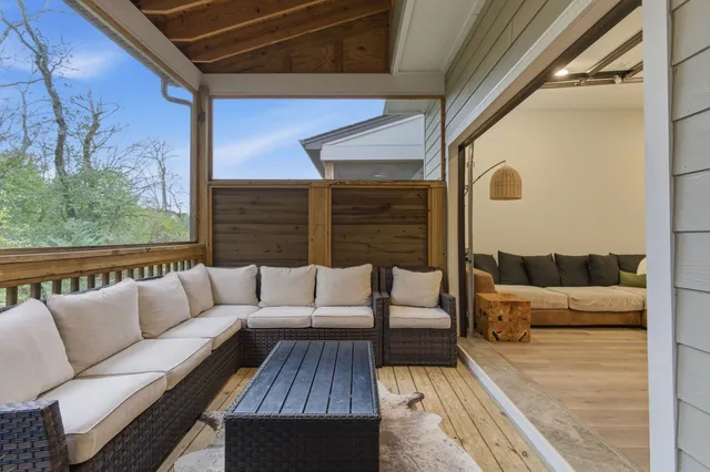a view of a patio with a table chairs and a backyard