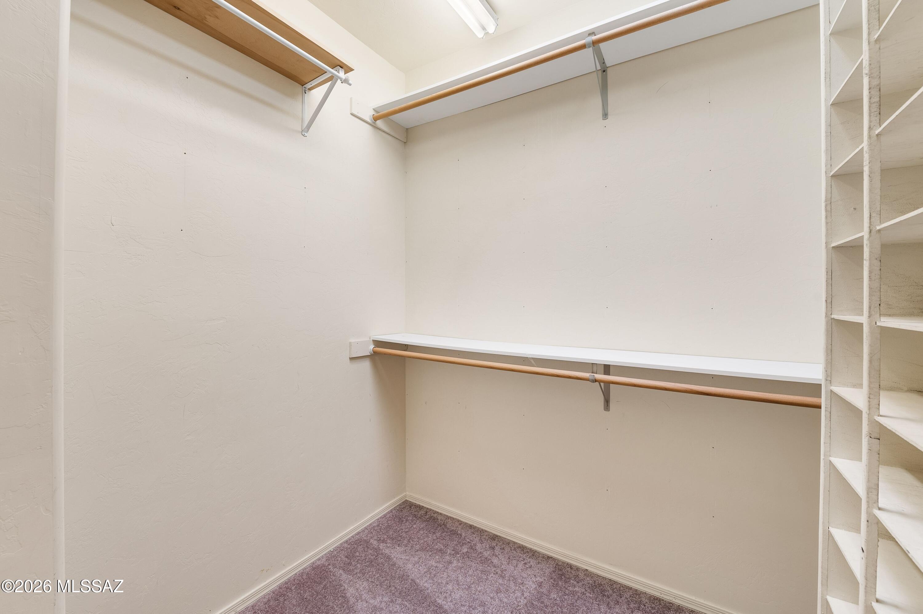 12160 East Tanque Verde Road Tucson, AZ 85749 - Photo 33 of 53 Built-in wood shelving with hanging rods.