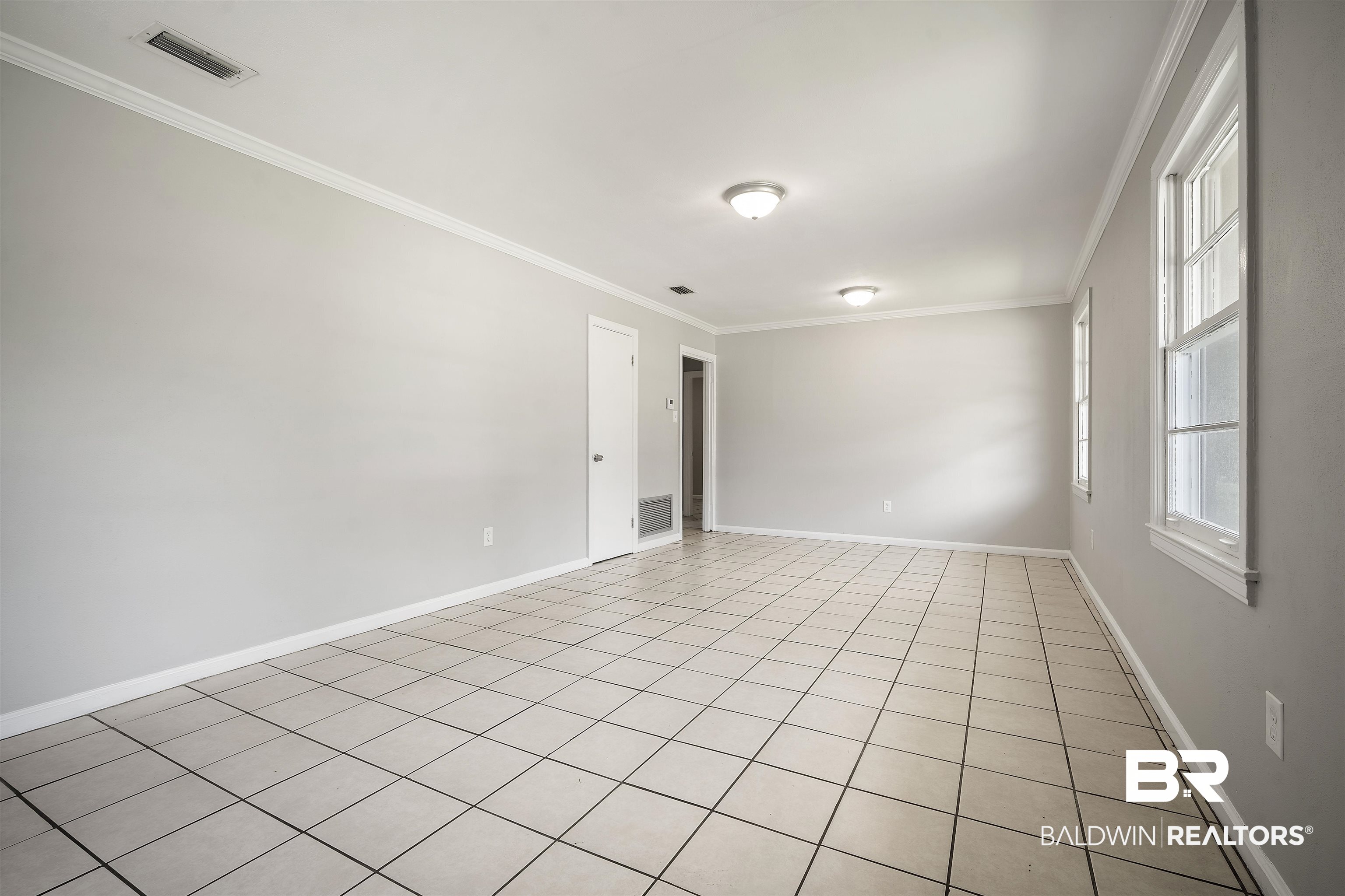 963 Shady Brook Drive Mobile, AL 36606 - Photo 5 of 20 Empty room with crown molding, baseboards, and light tile patterned flooring