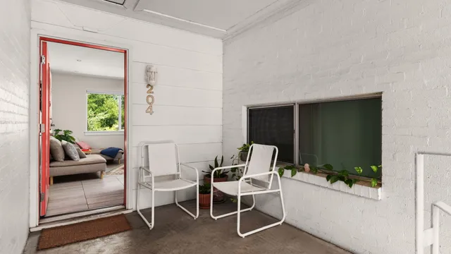 a living room with furniture and a potted plant