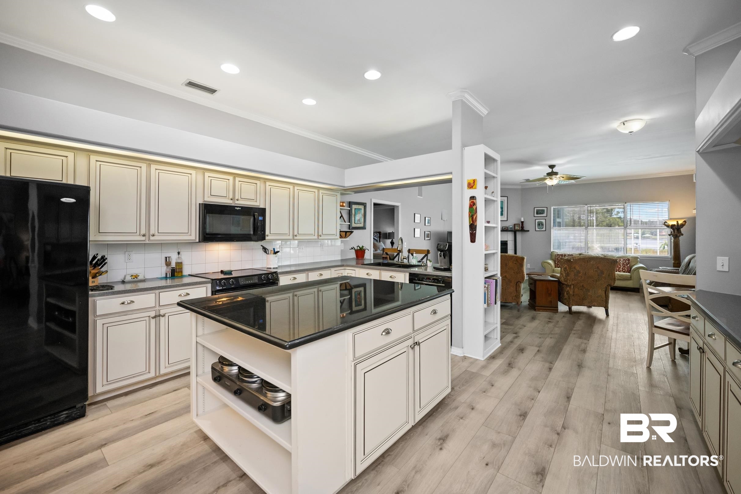 8585 Bay Harbor Road Elberta, AL 36530 - Photo 50 of 51 Kitchen with black appliances, open shelves, open floor plan, dark countertops, and a ceiling fan