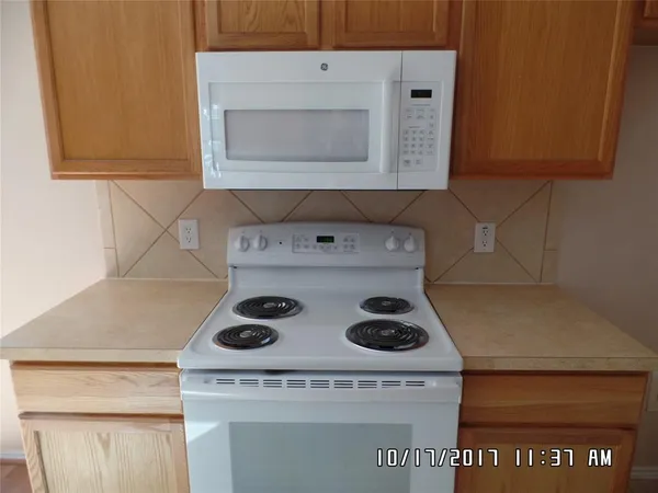 a kitchen with a stove and cabinets