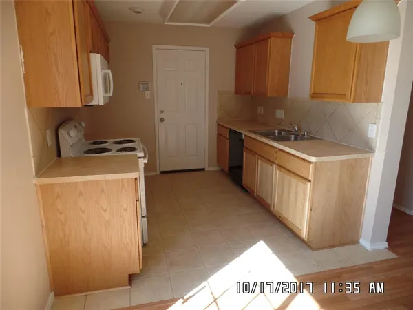 a kitchen with a stove and a refrigerator