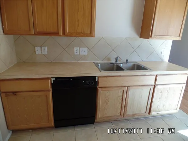 a kitchen with stainless steel appliances white cabinets and a sink