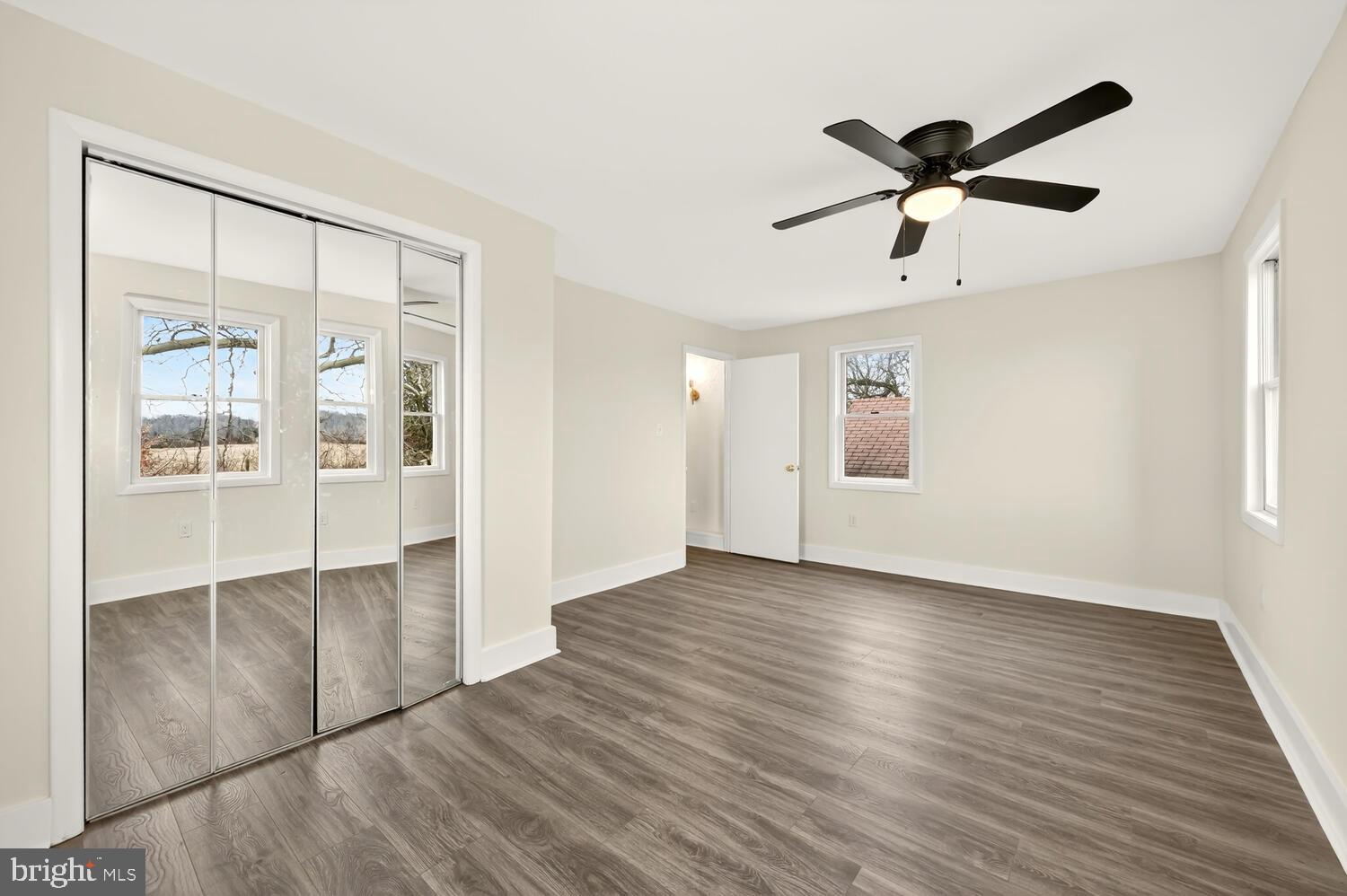 6746 Quaker Neck Road Chestertown, MD 21620 - Photo 44 of 50 a view of empty room with wooden floor and fan