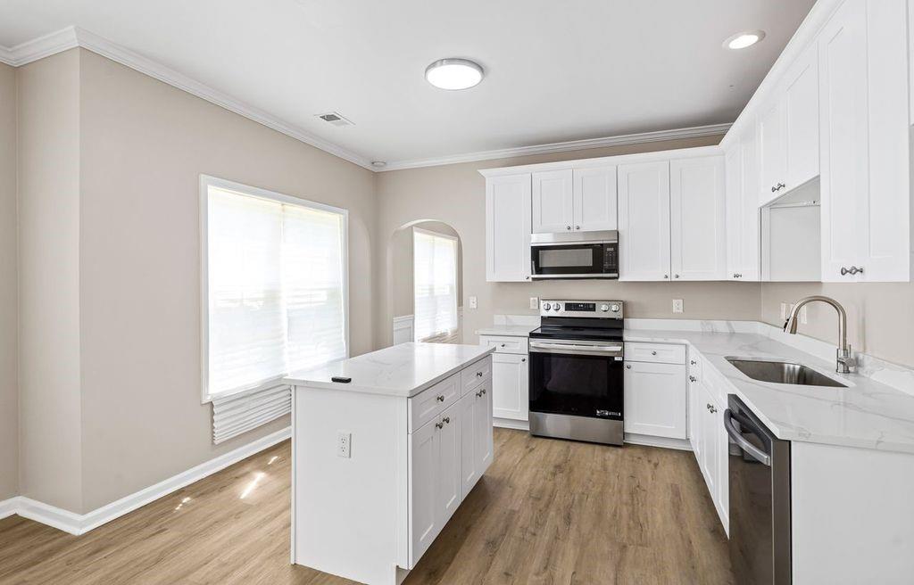 473 Greyhawk Way Fairburn, GA 30213 - Photo 11 of 34 a kitchen with granite countertop white cabinets and white appliances
