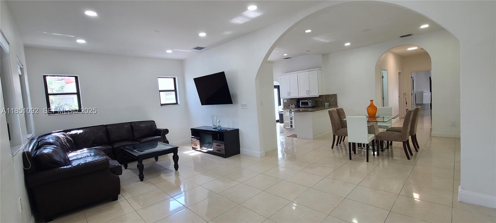 1721 Southwest 24th Terrace Miami, FL 33145 - Photo 16 of 80 a living room with furniture and a flat screen tv