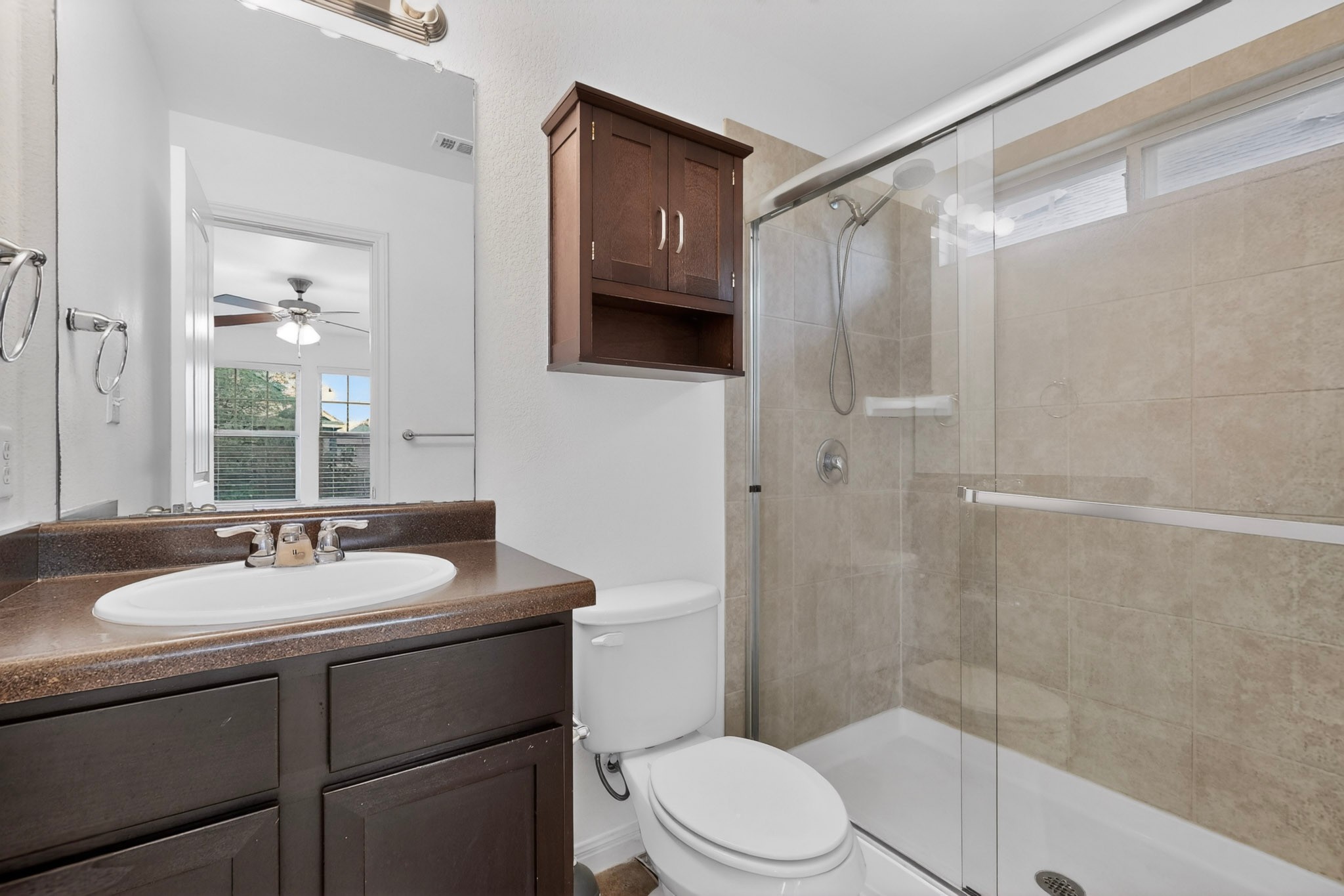 4619 Inicio Lane Austin, TX 78725 - Photo 19 of 32 a bathroom with a sink a toilet and shower