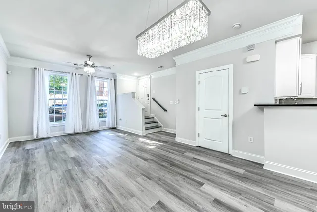 wooden floor chandelier and windows in a room