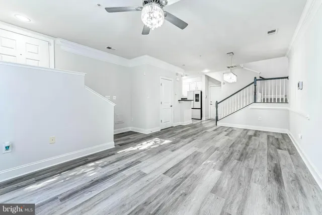 a view of a room with wooden floor and staircase