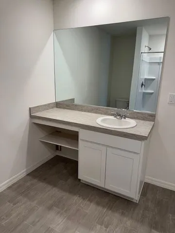a room with a sink and a mirror