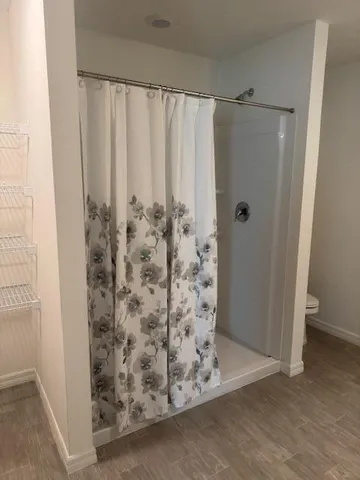 a view of a bathroom with a shower and a tub