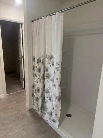 a bathroom with a shower and a sink