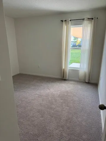 a view of an empty room and window