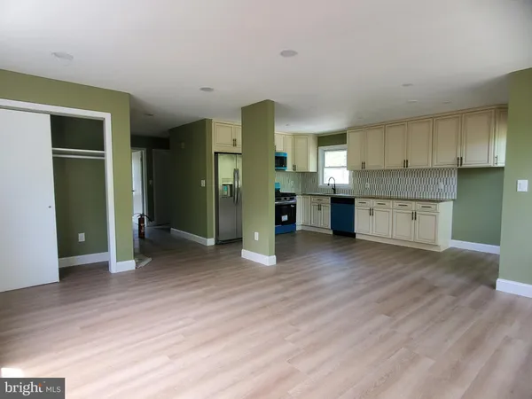a view of a kitchen with a sink and a refrigerator