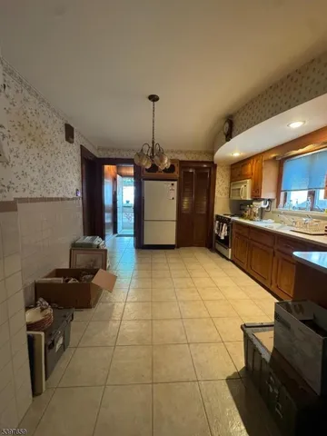 a kitchen with granite countertop a stove a sink and a counter top space