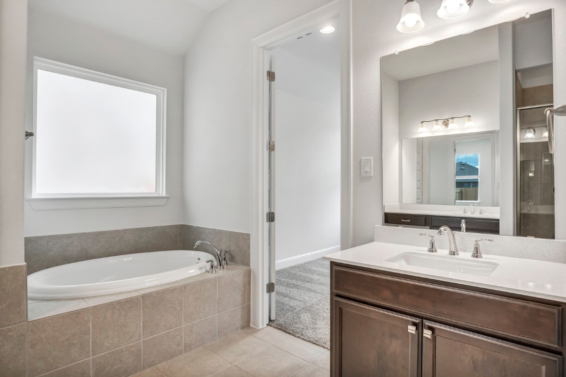 2313 Base Burner Path Leander, TX 78641 - Photo 16 of 26 a bathroom with a bathtub and a sink