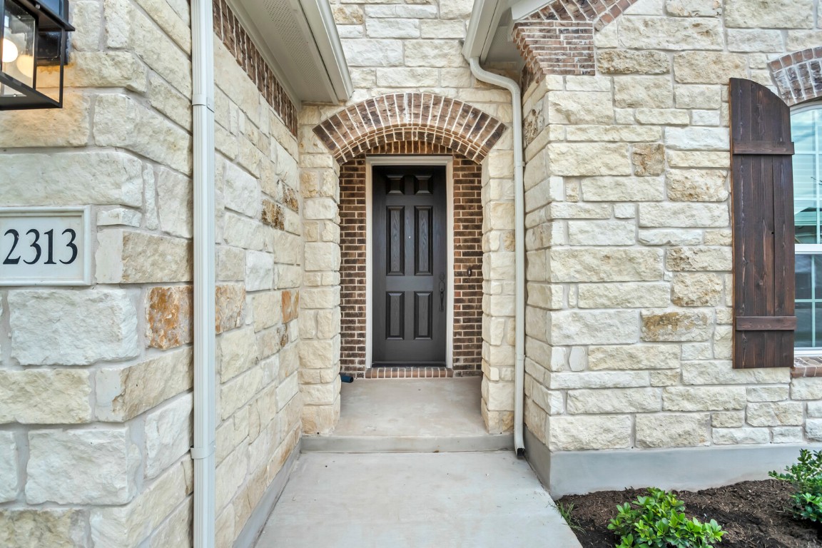 2313 Base Burner Path Leander, TX 78641 - Photo 2 of 26 a front view of a house with a door