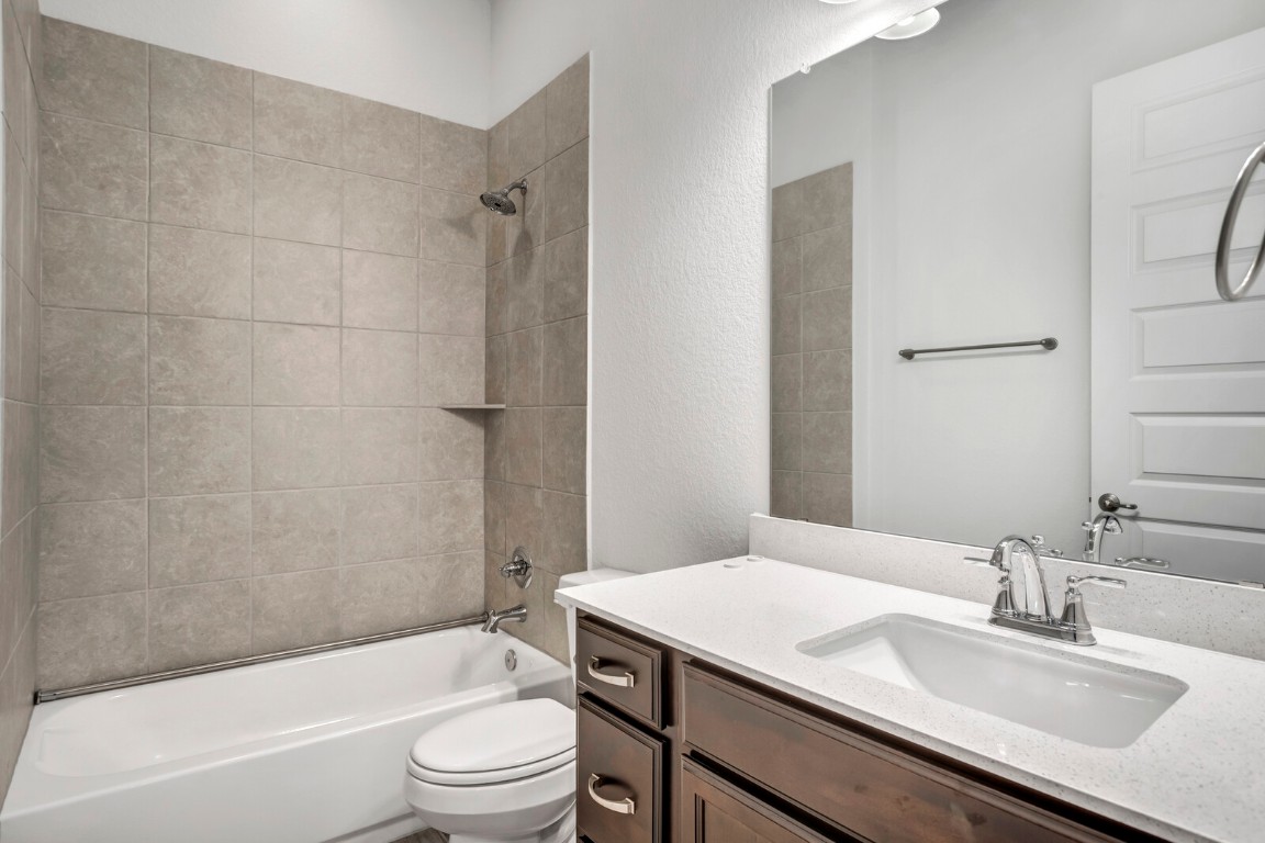 2313 Base Burner Path Leander, TX 78641 - Photo 24 of 26 a bathroom with a granite countertop sink toilet tub and shower