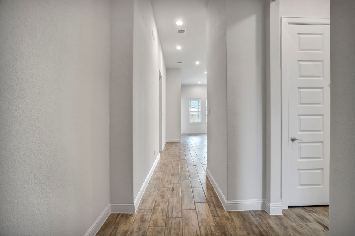 2313 Base Burner Path Leander, TX 78641 - Photo 3 of 26 a view of a hallway with wooden floor