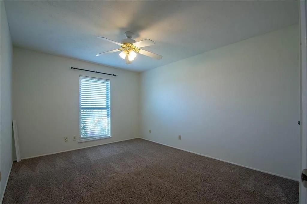 6500 Blue Ridge Trail Plano, TX 75023 - Photo 4 of 14 Carpeted room with a ceiling fan light fixture, a window with horizontal blinds, and neutral painted walls
